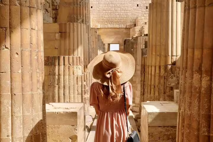 Traveler walking through Saqqara stone columns near Giza, Egypt on a 2-day private guided tour