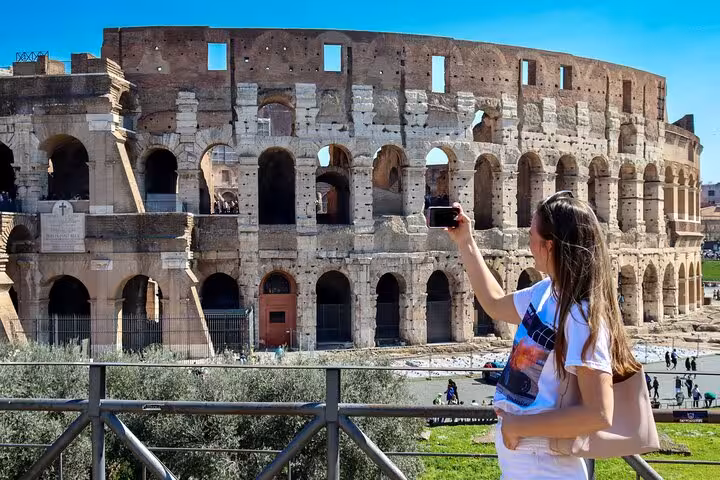 Traveler taking a selfie at the Colosseum in Rome on a self-guided tour with Palatine Hill and Roman Forum