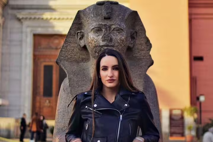 Traveler in front of ancient sphinx statue in Cairo, part of 2-day Luxor to Cairo and Alexandria by flight trip
