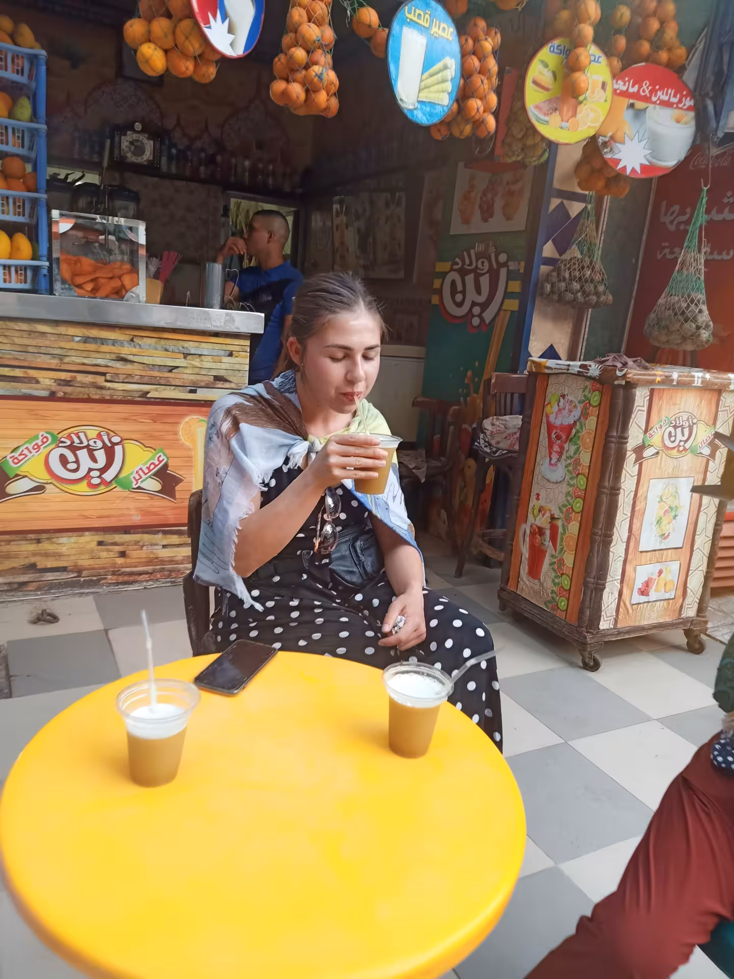 Traveler sipping fresh sugarcane juice at a Cairo street stall on a private food tour and funny walking experience