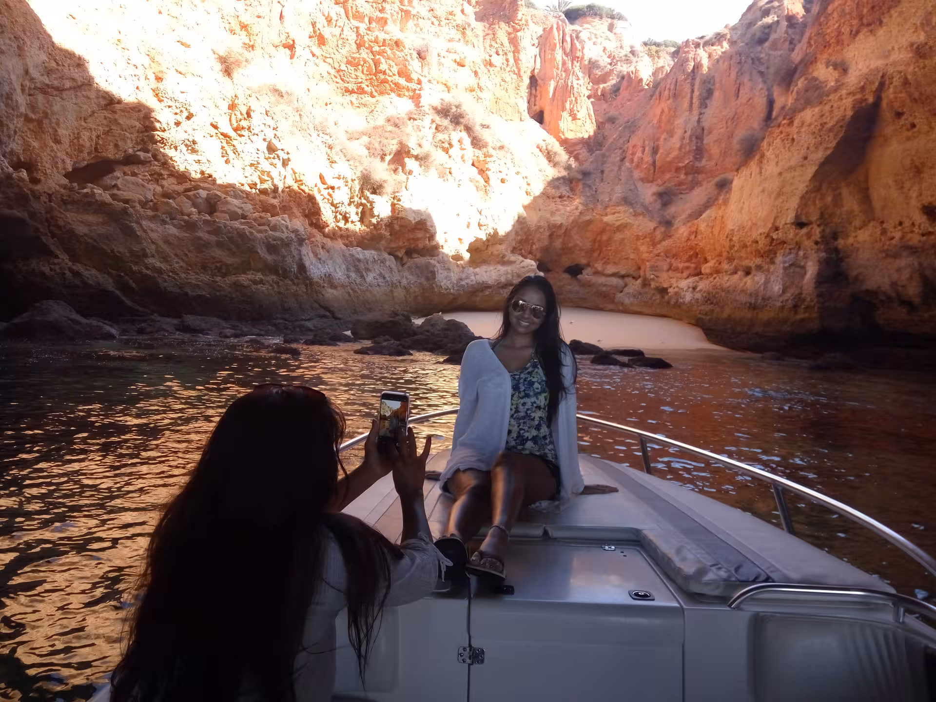 Traveler poses for photos on a yacht inside a dramatic Algarve sea cave during the Seasiren Private Tour 3H experience