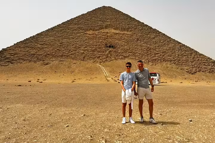 Travelers posing at the Great Pyramid of Giza, part of a 2-day Ancient Egypt tour with pyramids and museums