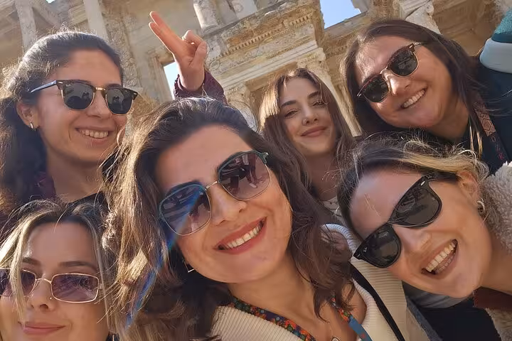 Smiling travelers selfie at Ephesus ancient ruins, unforgettable moment on 8-day Cappadocia Ephesus Antalya tour