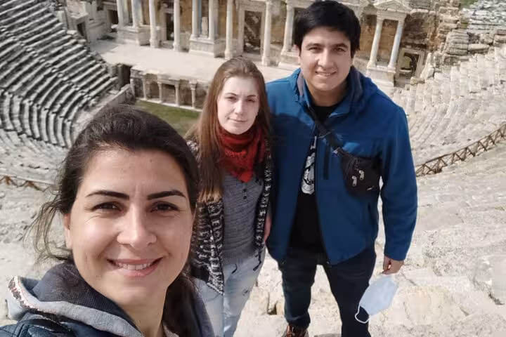 Travelers selfie at Hierapolis ancient theater during a private Pamukkale tour from Denizli Airport