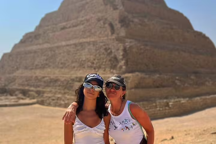 Travelers posing by the Step Pyramid of Djoser in Saqqara, Egypt, on a Memphis and Sakkara day tour