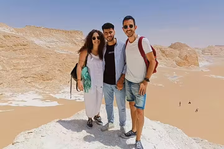 Travelers posing on White Desert cliffs in Bahariya Oasis, Egypt, on a 4-day private Cairo adventure tour