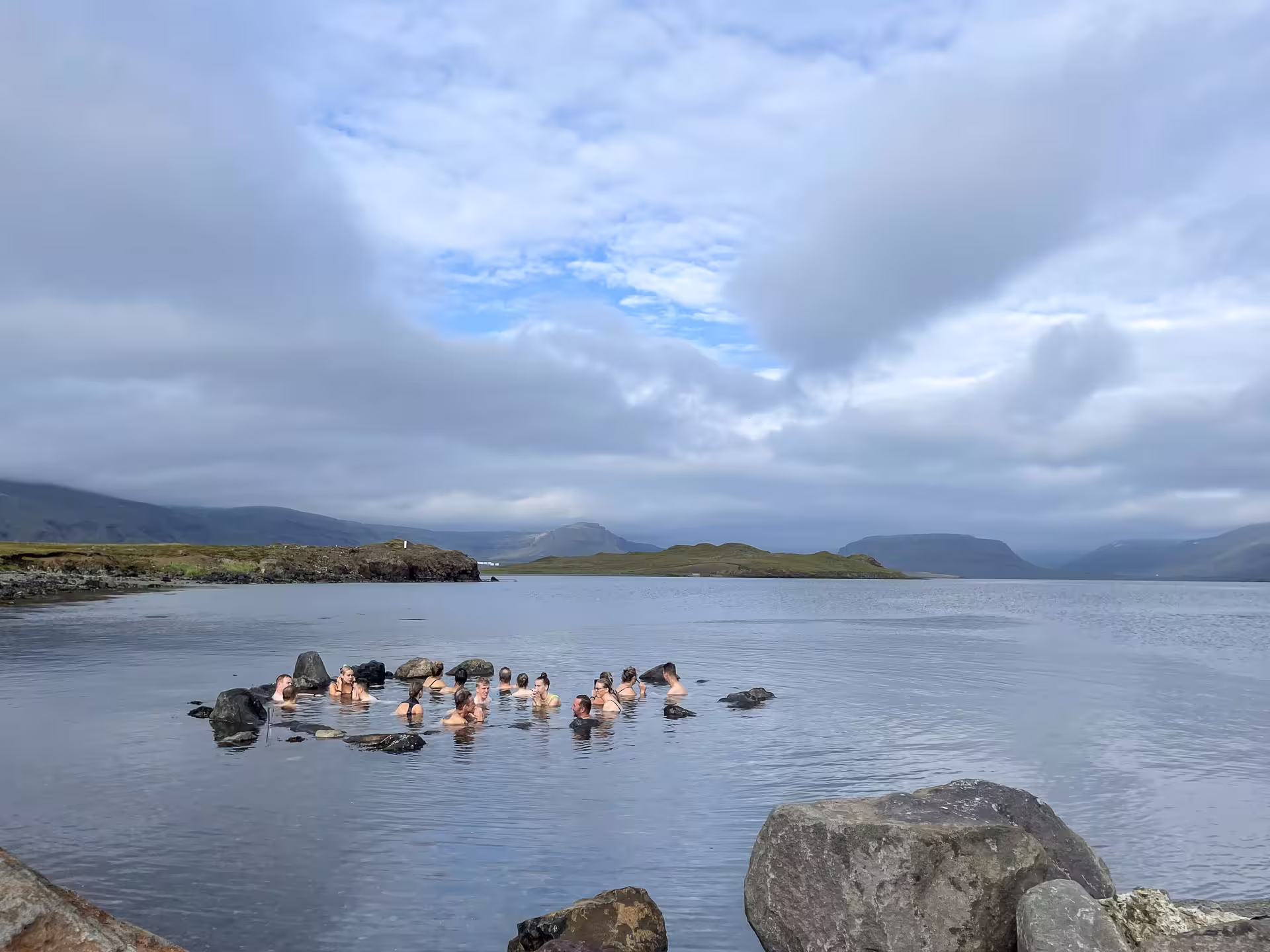 A group of travellers taking a bath in the hot springs 
