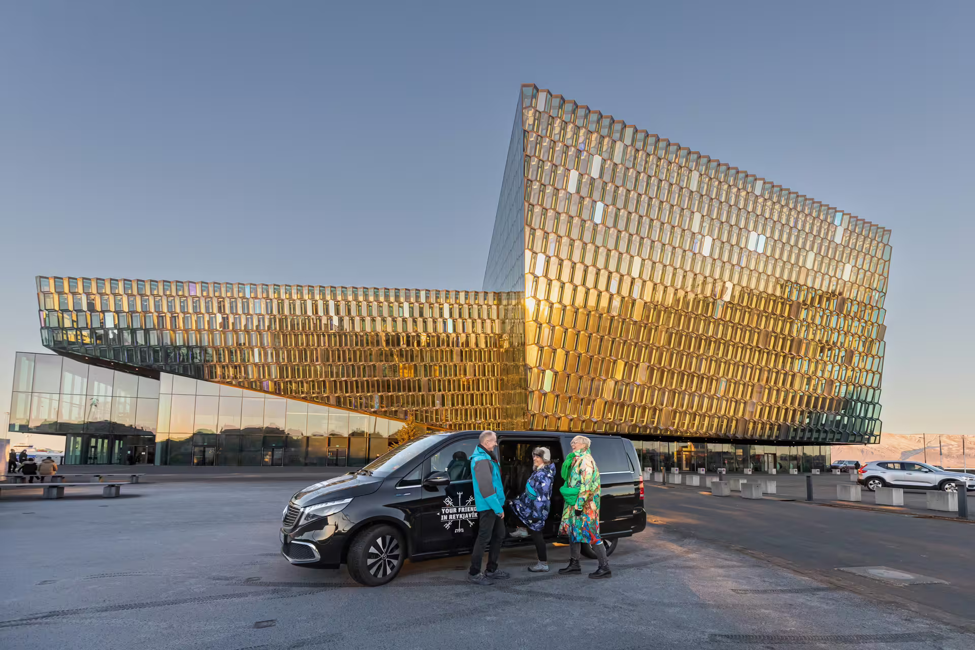 Travellers in front of a tour vehicle from Your Friend in Reykjavik