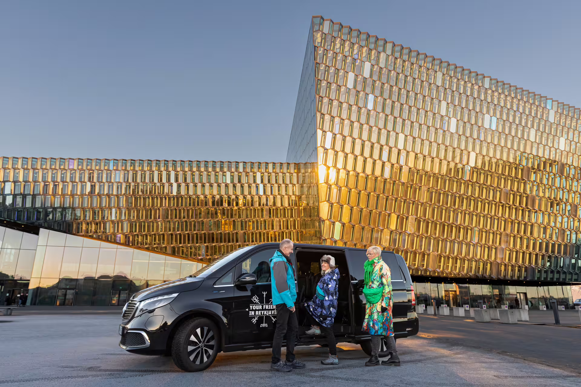 Travellers in front of the Harpa Concert Hall in Reykjavik