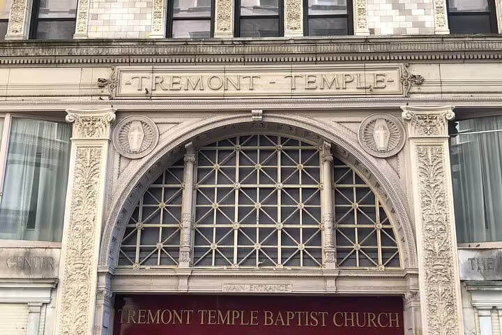 Ornate facade of Tremont Temple Baptist Church with arched window and decorative stonework in Boston