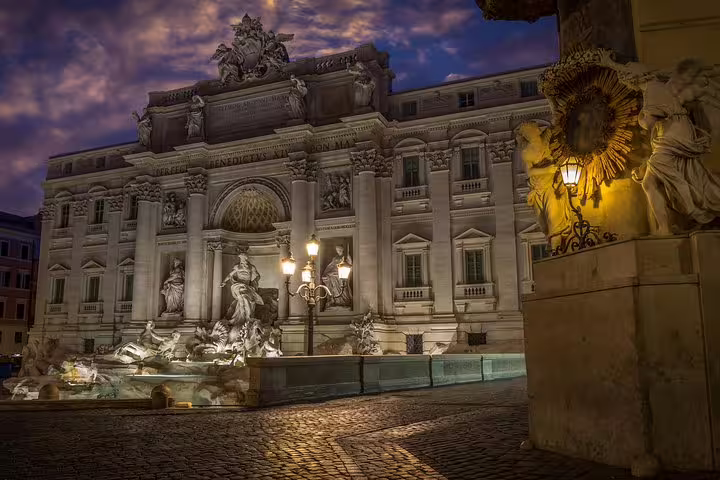 Trevi Fountain beautifully lit at night on a Best of Rome private chauffeured sightseeing tour with pickup and drop-off