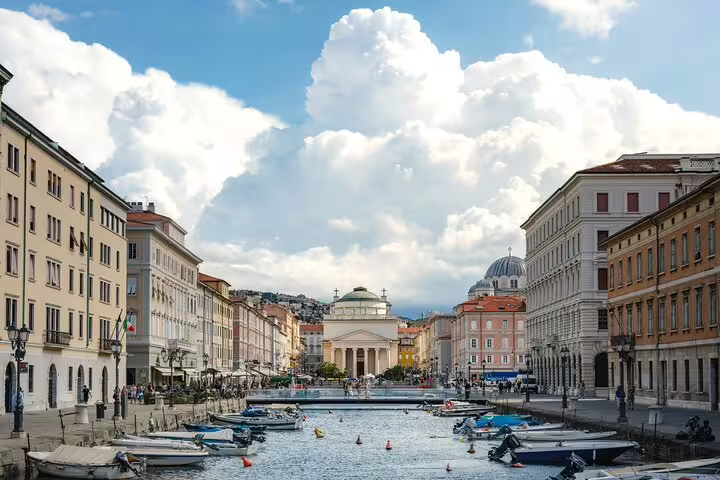 Daytime scene of Trieste’s Grand Canal and neoclassical churches explored on a Trieste Hidden Gems walking tour