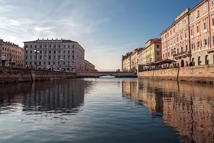 View of Trieste Grand Canal with historic palaces and reflections in the water on a guided private walking tour