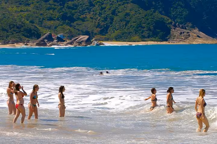 Visitors enjoying the crystal-clear waters and scenic views at Trinidad's beaches, perfect for a relaxing getaway.