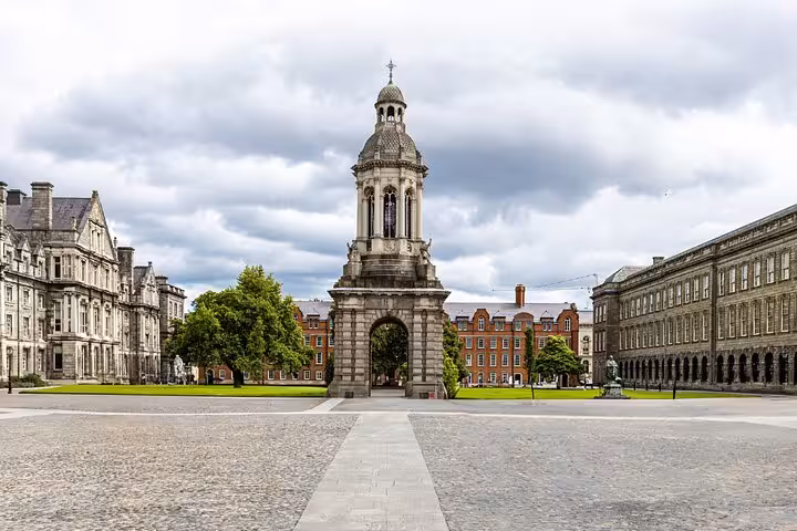 Trinity College Dublin campanile bell tower in cobblestone Parliament Square on a cloudy day
