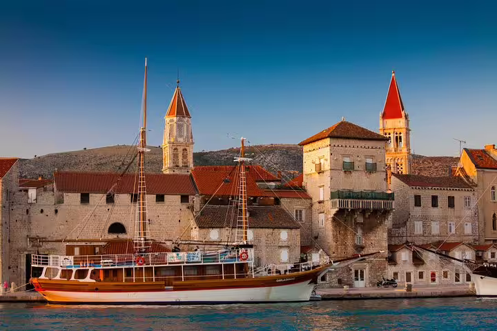 Trogir waterfront with traditional boat and historic towers, Dalmatian coast scenery on a private walking tour