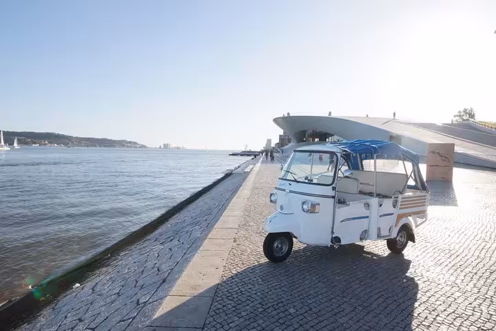 Tuk tuk parked by Tagus River in Belém Lisbon near MAAT, perfect for 2-hour private tour with Belém pastries