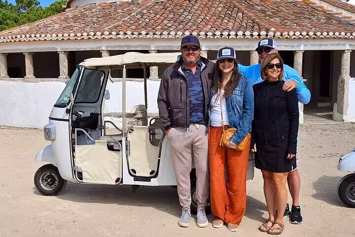 Group photo by tuk tuk at a historic Sintra site, private Tuk Tuk Tour to palaces and Cascais coastline