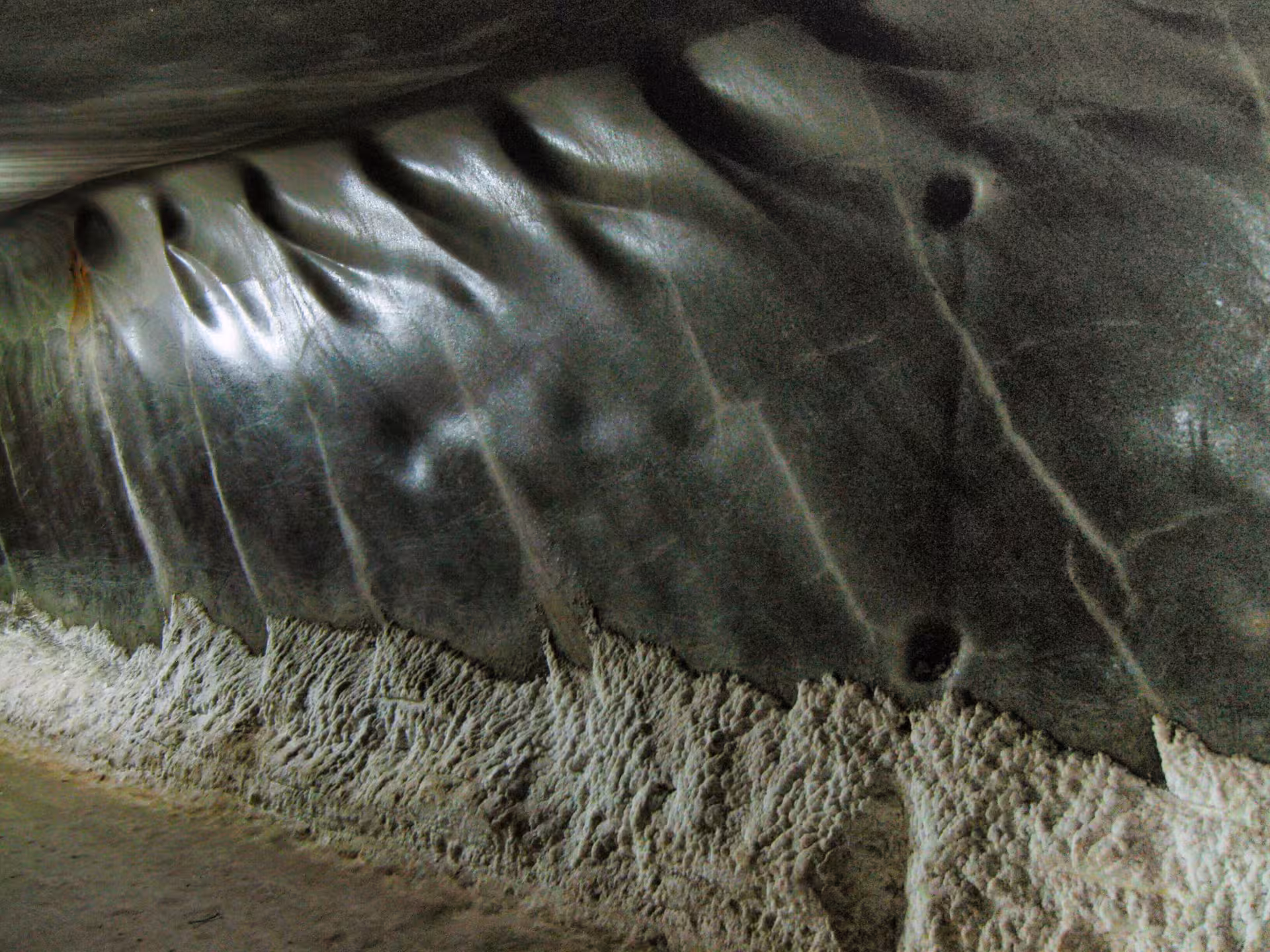 Close-up of ancient carved salt walls with textured formations inside Turda Salt Mine on a Cluj day trip