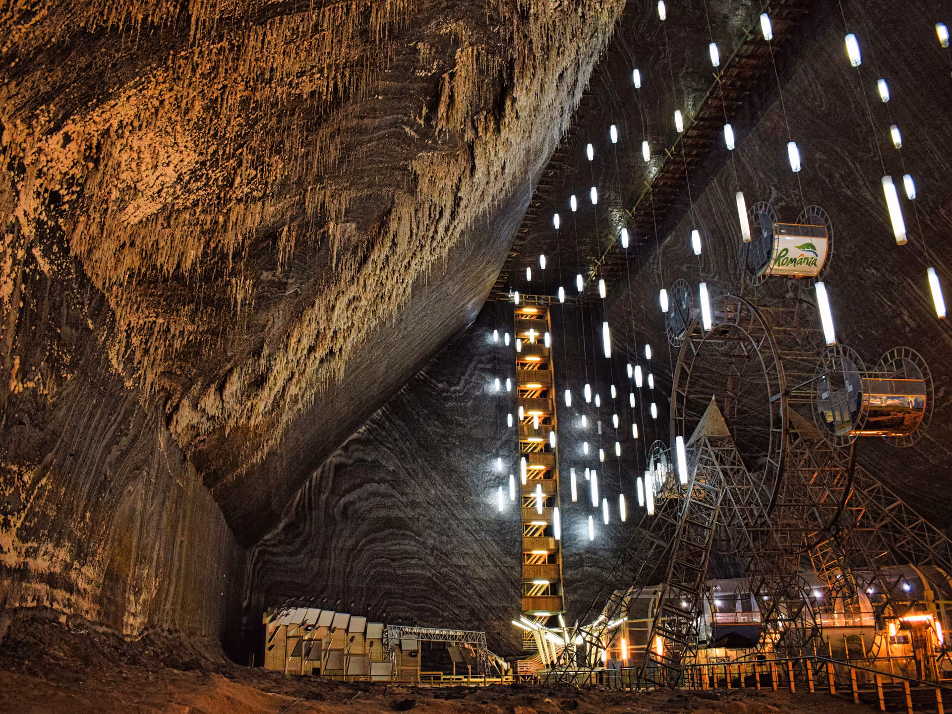 Turda Salt Mine interior showcasing Ferris wheel and dramatic salt-layered walls on a Romania day trip from Cluj