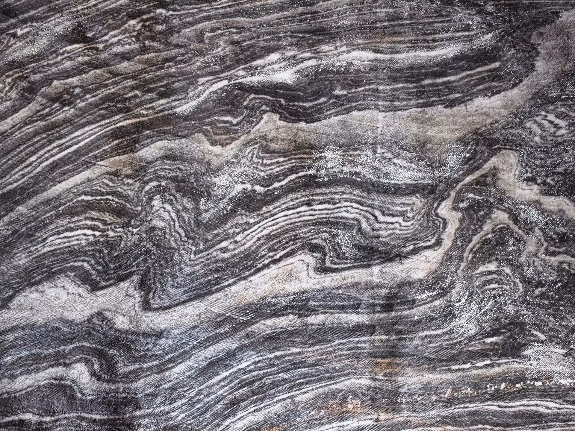 Close-up of ancient swirling salt rock layers on Turda Salt Mine walls revealing geological history on a Cluj guided tour