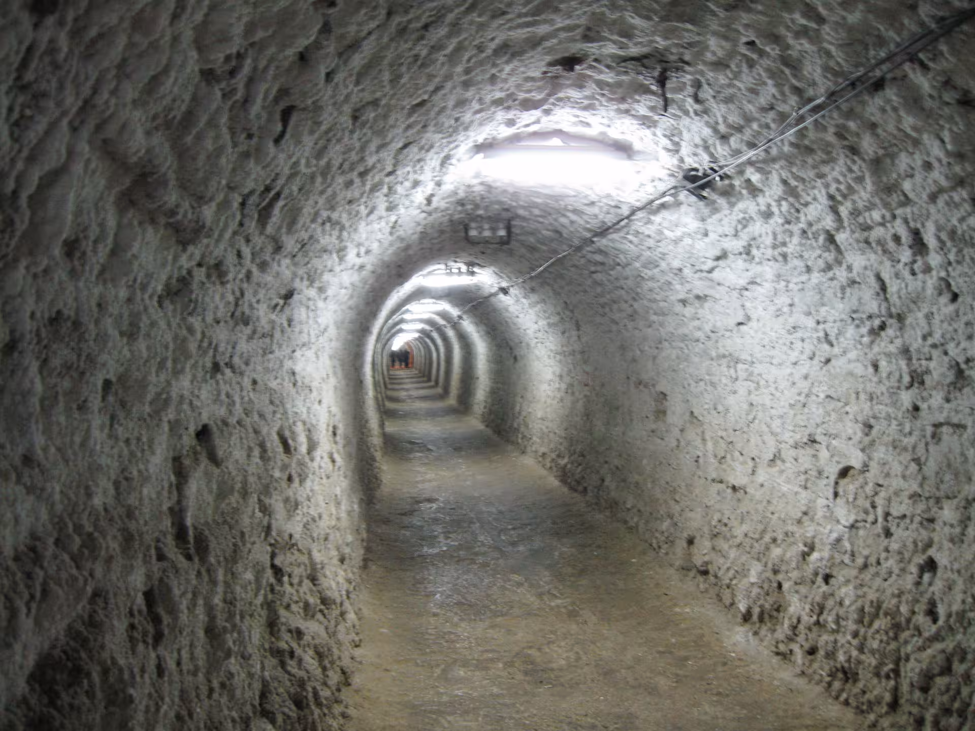 Long arched salt tunnel passage deep underground at Turda Salt Mine guided tour from Cluj