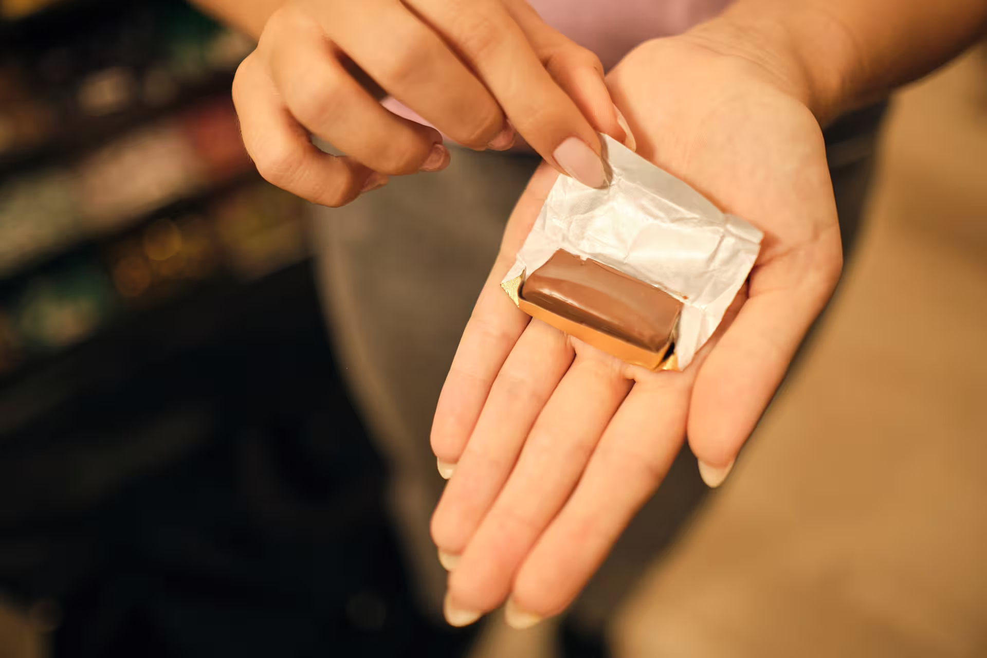 Unwrapping artisan gianduja chocolate during Turin chocolate and wine tasting tour in a local shop