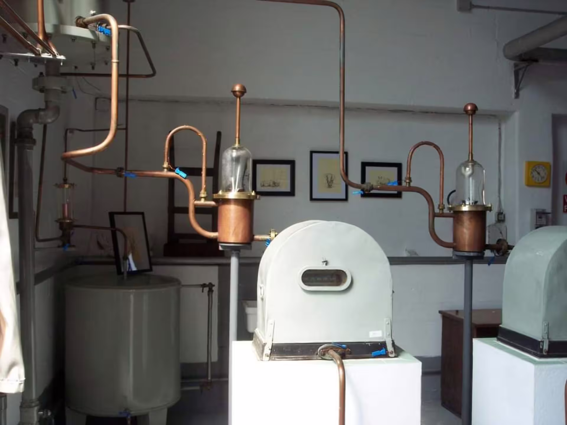Interior of Turin distillery with traditional copper distillation equipment and industrial decor.