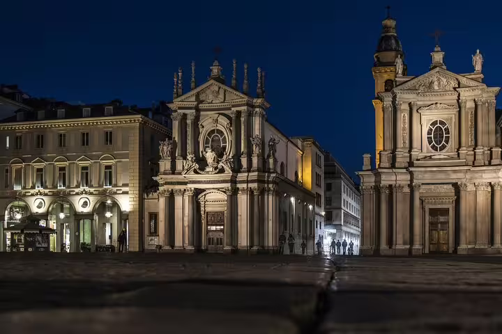 Evening view of illuminated baroque churches in Piazza San Carlo Turin featured on a private personalized walking tour