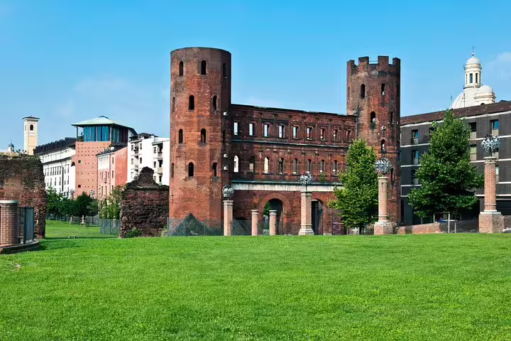 Turin scavenger hunt stop at Palatine Towers and Porta Palatina ruins in sunny park, self-guided tour
