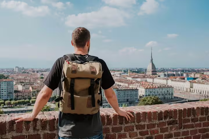 Visitor on a Turin Top Sights personalized walking tour admiring panoramic skyline views and the Mole Antonelliana landmark