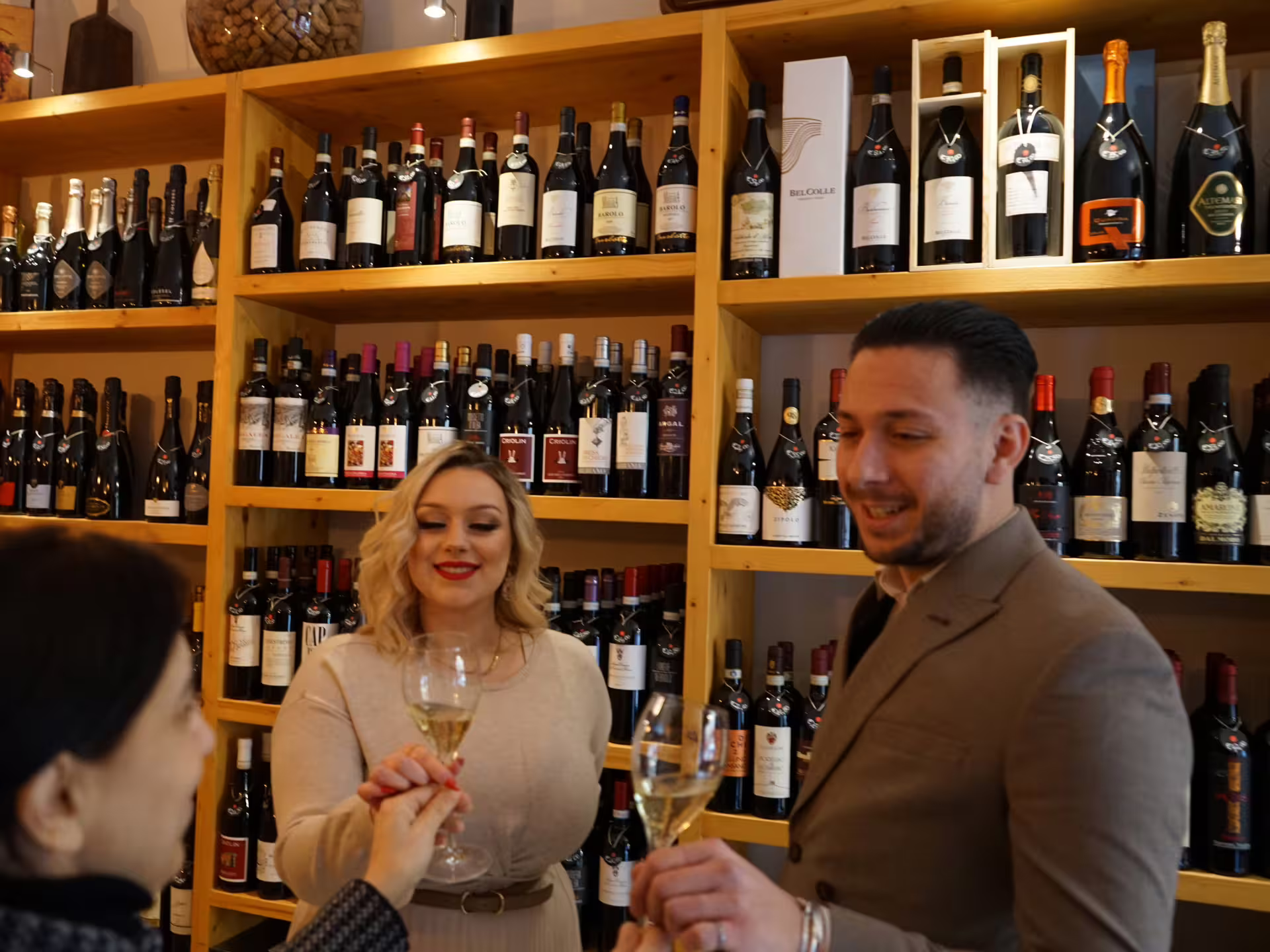 Guests toasting with white wine during an easy Turin city center wine tasting tour at a local enoteca