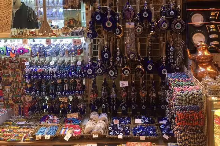 Colorful Grand Bazaar souvenir stall with evil eye charms and Turkish jewelry on 11-day small group Turkey tour