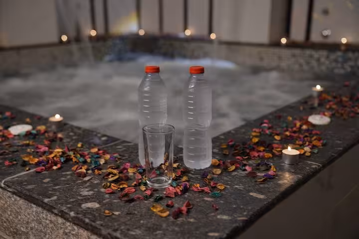 Refreshing water bottles by candlelit jacuzzi after Turkish bath spa program, Sharm El Sheikh full treatment