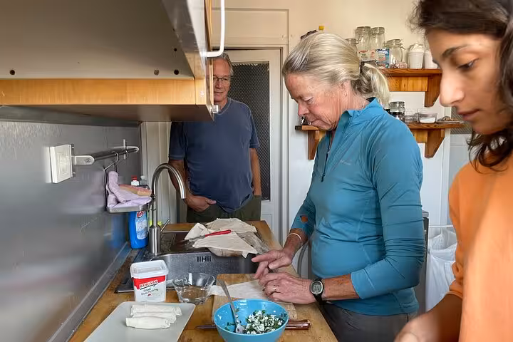 Guest chopping herbs for Turkish breakfast mezze in a local home kitchen during Istanbul cooking class
