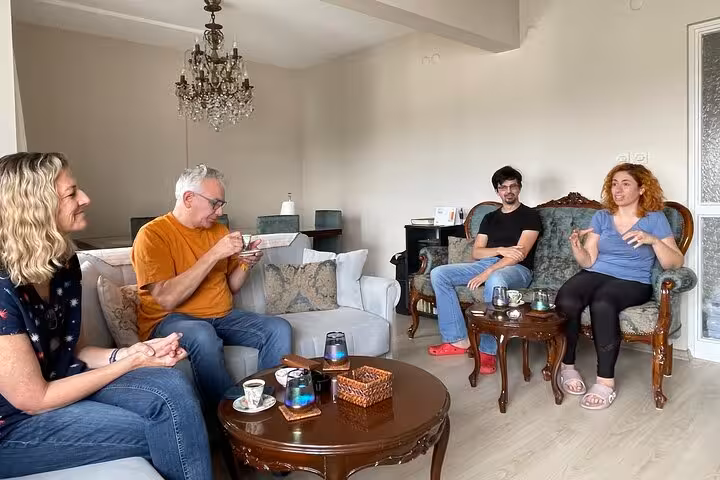 Guests enjoy Turkish tea and conversation in a local Istanbul home during an authentic cooking class