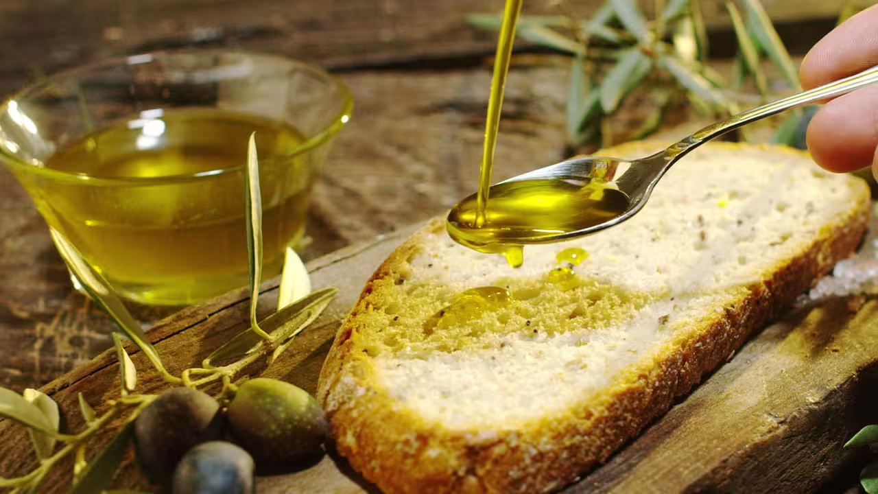 Tasting Tuscan extra virgin olive oil on bread with olives during Fiesole Olio Evo Gold Experience