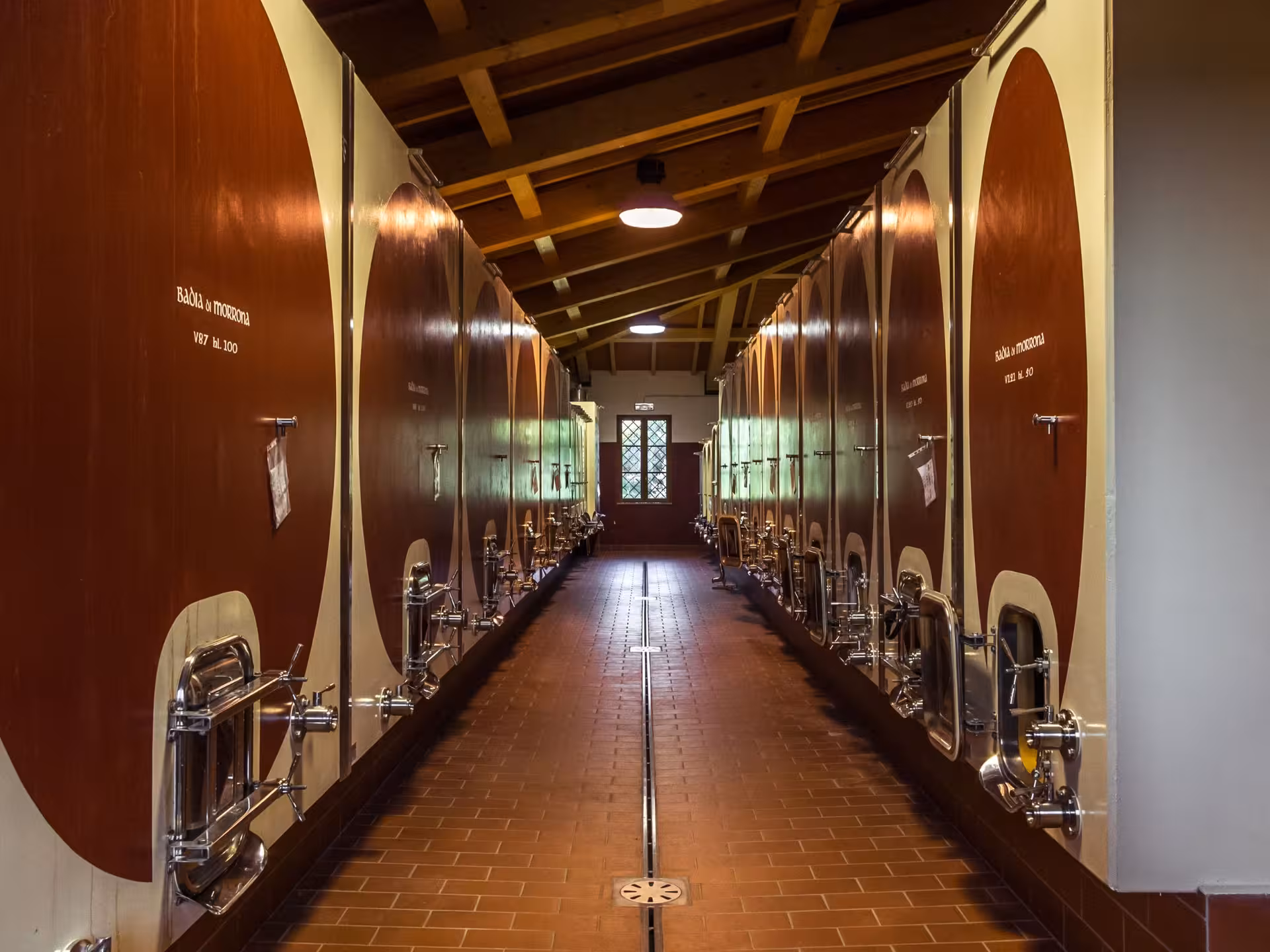 Discover traditional wine fermentation tanks in the Tuscan winery, a highlight of our Abbey Tour and Wine Tasting near Pisa.