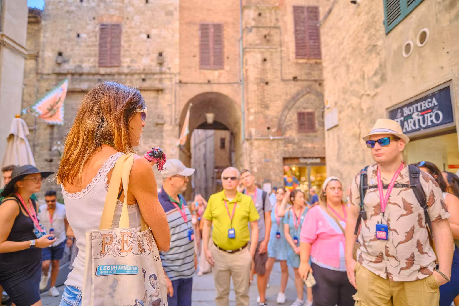 Small group exploring historic streets on the Tuscany Highlights Tour from Florence.