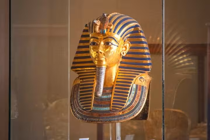 Tutankhamun golden funerary mask display at the Grand Egyptian Museum on a Cairo Egyptologist tour