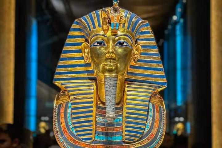 Tutankhamun golden funerary mask on display at the Grand Egyptian Museum, a highlight of Giza day tours