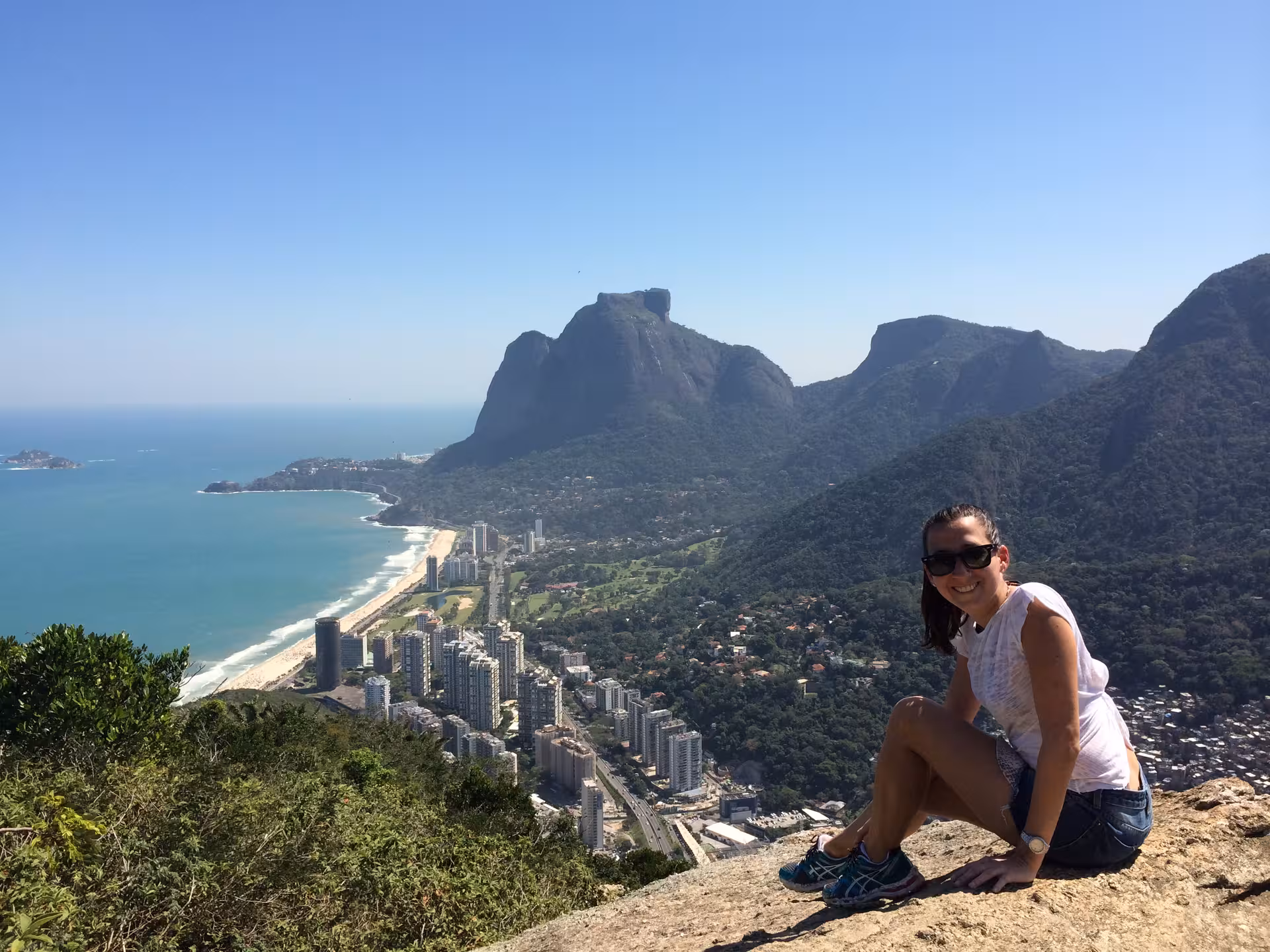 Smiling woman enjoying the panoramic view from Two Brothers Hill, overlooking Rio's beaches and mountains.