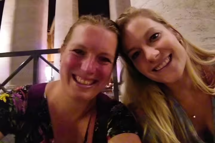 Two smiling women posing together indoors during Angels and Demons walking tour in Rome