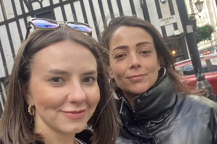 Two women smiling for a selfie on Phoenix Street in Manchester city centre