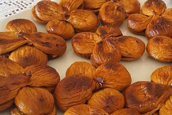 Plate of traditional sun-dried figs served during lunch on a Tyrrhenian Sea walking tour showcasing local Calabrian flavors