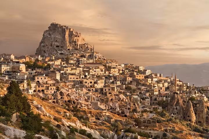 Uchisar Castle and cave houses at golden hour, Cappadocia 1 day guide tour with comfortable car service