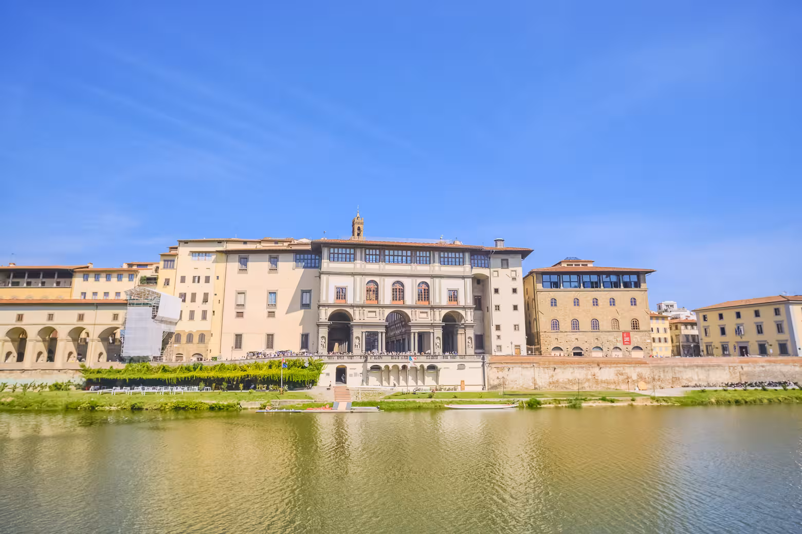 View of Uffizi Gallery along the Arno River on a sunny day, part of a full day Florence and Pisa shore excursion.