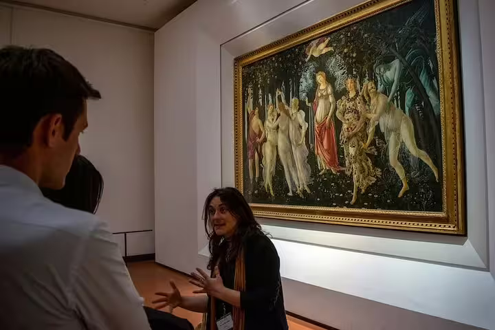 Local guide explaining Botticelli’s Primavera to a small group during an Uffizi Gallery guided tour in Florence