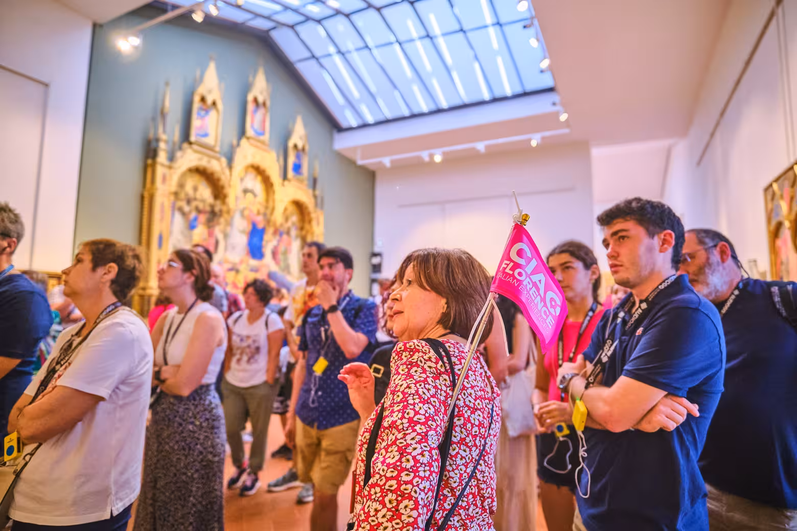 Guided group observes artwork in Florence's Uffizi Gallery, experiencing skip-the-line convenience and expert insights.