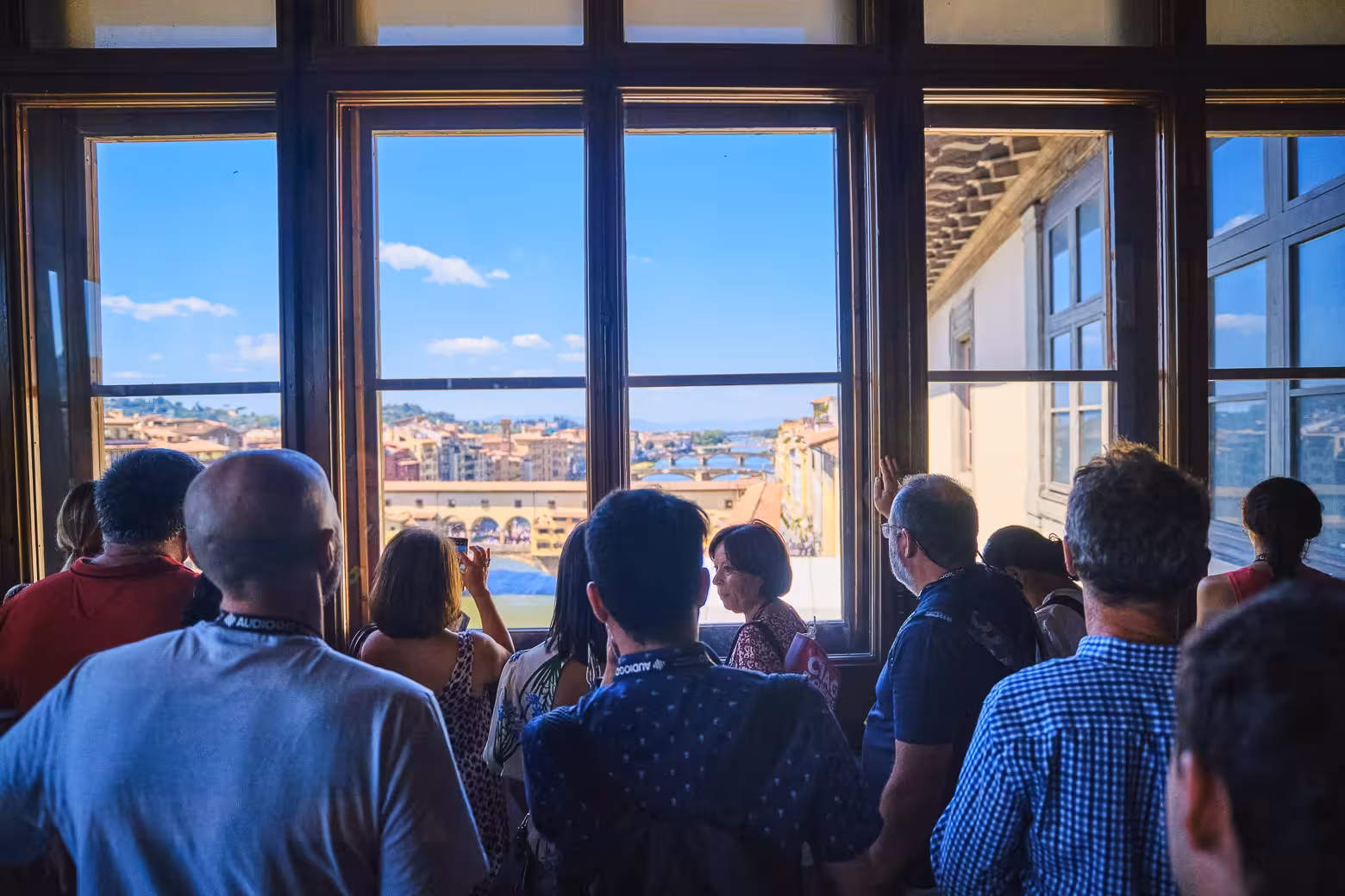 Tourists enjoy a panoramic view of Florence from the Uffizi Gallery, highlighting the exclusive private tour experience.